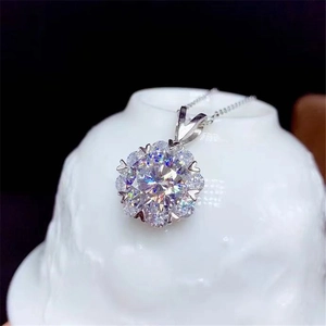 Macro shot of 2 carat heart-shaped moissanite pendant with silver chain detail