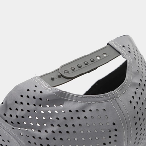Detail of laser-cut perforated fabric and plastic snapback closure on baseball cap