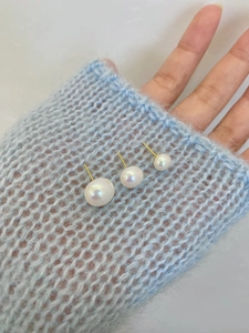 Detailed comparison of 6mm, 8mm, and 10mm pink pearl stud earrings on a sleeve