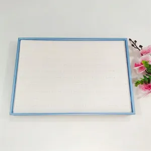 Detail view of large 100-slot jewelry display tray for rings and stud earrings