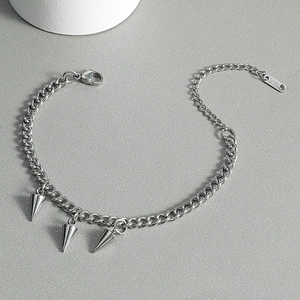 Industrial 316L stainless steel chain bracelet with cone spikes on a grey background