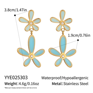 Detail of light blue enamel flower earrings in 18K gold plated stainless steel