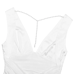 Close-up of white satin dress with deep V-neck and elegant pearl chain back detail