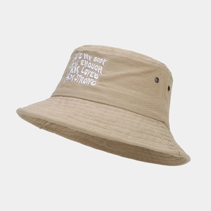 Detail of khaki cotton bucket hat featuring white motivational embroidery and air eyelets