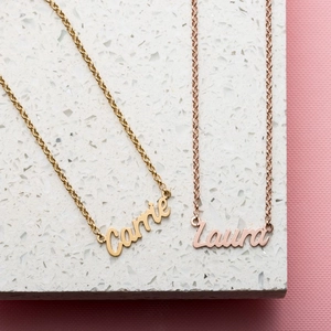 Detailed view of custom name necklaces in gold and rose gold finish with fine link chains