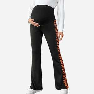 Macro shot of pregnancy flared pants featuring orange leopard side stripes and belly support