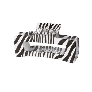 Detail view of large rectangular hair claw clip with black and white zebra print texture