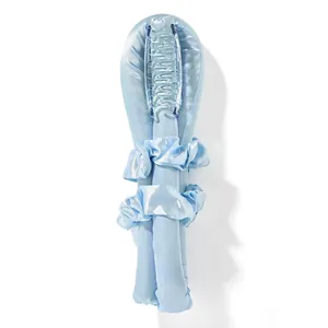 Close-up of light blue heatless hair curler set with satin scrunchies and plastic hair claw