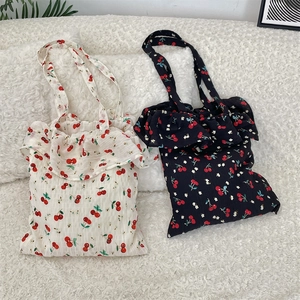 Close-up of cherry print canvas tote bag with ruffled chiffon trim and large capacity