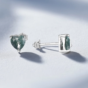 Macro shot of S925 sterling silver heart earrings featuring green moss agate stones