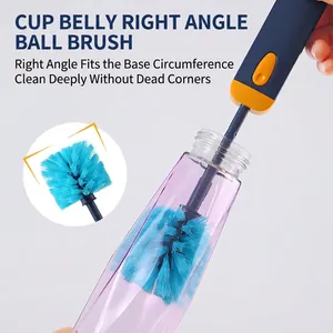 Long handle cup brush with blue bristles cleaning the bottom of a purple narrow bottle