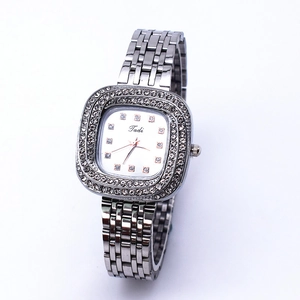 Detailed macro view of square silver watch dial with luxury rhinestone encrusting
