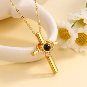 Golden heart and cross projection necklace with white zircons and black center stone