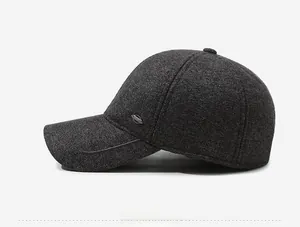 Detail view of dark grey wool baseball cap showing side profile and metal emblem