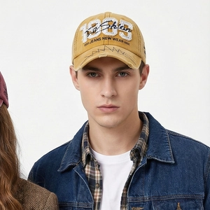 Vintage mustard yellow baseball cap with 1985 3D embroidery and distressed brim details