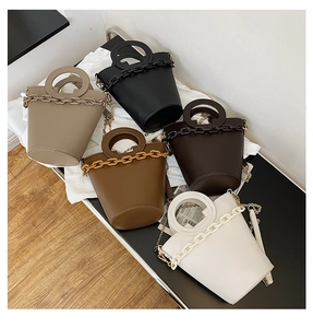 Top view of bucket bags in beige, black, brown, and white with circular handles and chains
