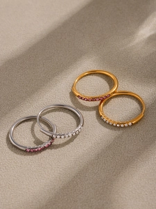 Close-up of gold and silver plated pave zirconia hoop earrings in natural light