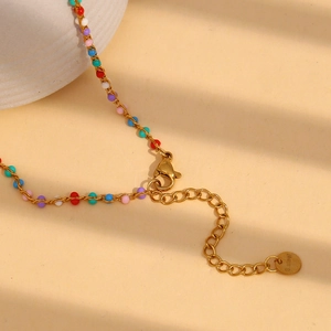 Macro shot of 18K gold plated stainless steel necklace with lobster clasp and colorful beads