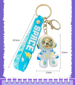 Detailed dimensions of blue and white astronaut keychain with silicone strap and alloy hook
