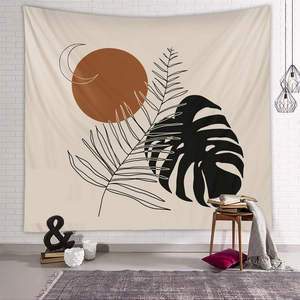 Detail view of Boho tapestry with sun and leaf motifs hanging in a cozy living room scene