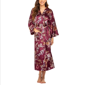 Detail of burgundy floral satin long sleeve robe with waist belt on white background