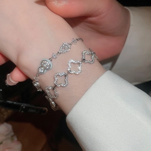 Detail view of 18k gold plated bracelets with pearls and sparkling zircon on woman wrist