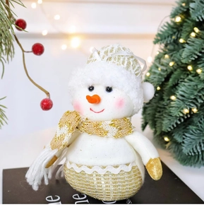 Detailed close-up of a plush snowman Christmas ornament on a decorative book stand