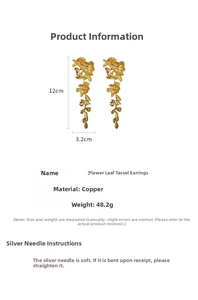 Detailed view of long gold tassel earrings with hollow floral and leaf motifs in copper