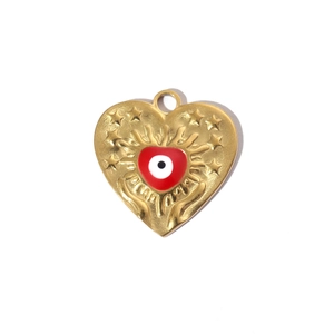 Detail of gold heart pendant with evil eye enamel and embossed star pattern