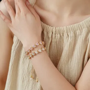 Elegant double-layered gold heart bracelet with pink and white cubic zirconia crystals