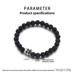 Detail view of 8mm black volcanic rock beads and 13mm metal Buddha head charm on elastic bracelet