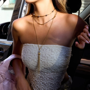 Three-layer 18K gold and silver stainless steel tassel necklaces styled on a model