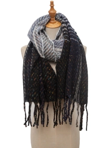 Close-up of knit scarf with gradient black, blue, and grey weave and fringe detail