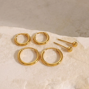 Golden 18k plated stainless steel earring set featuring polished hoops and studs