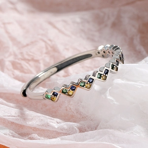 Detailed close-up of wavy S925 silver ring with colorful green, blue and yellow zircons