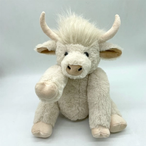 Macro detail of the cream-white Highland Cow plush showing soft faux fur and curved horns