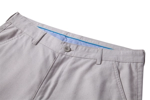 Detail of grey cotton linen trousers showing waist stitching and striped lining