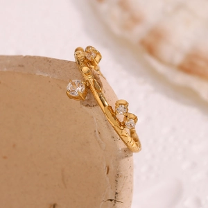 Macro detail of 18K gold plated crown ring with micro-set white zircon on ceramic