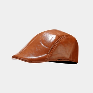 Detail view of caramel brown faux leather beret hat showing premium grain texture