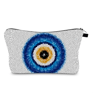 Detail of water-resistant toiletry bag with mosaic evil eye print and smooth metal zipper