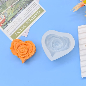 Detail showing heart rose silicone mold with finished orange wax candle against blue backdrop