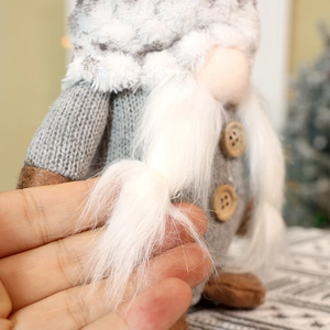 Close-up of plush Christmas gnome with long white beard and knit hat texture