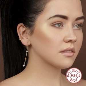 Elegant 925 sterling silver long tassel earrings with white pearls on a model