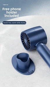 Deep blue handheld mini turbo fan on a grey stone base used as a mobile phone holder