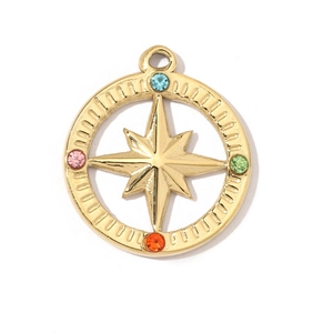 Macro shot of gold star compass pendant with blue pink green and orange rhinestones