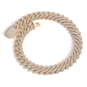 Macro shot of gold hip hop Cuban chain necklace with sparkling full zircon pavé setting
