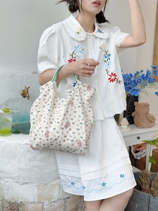 Minimalist cream floral bear canvas tote bag with green handles for beach or daily use