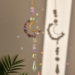 Detail of moon-shaped suncatcher with purple crystals and sparkling prism pendants