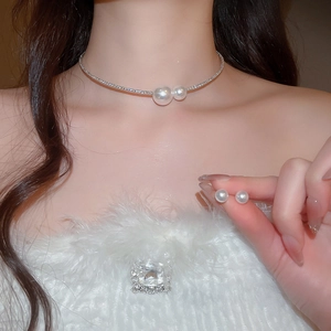 Close-up of model wearing an elegant silver choker with pearls and matching stud earrings