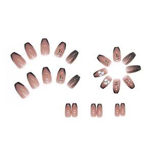 Press-on coffin nails with black french tips, silver glitter, and rhinestone accents